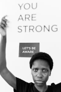 A powerful monochrome image highlighting strength and awareness against illness.