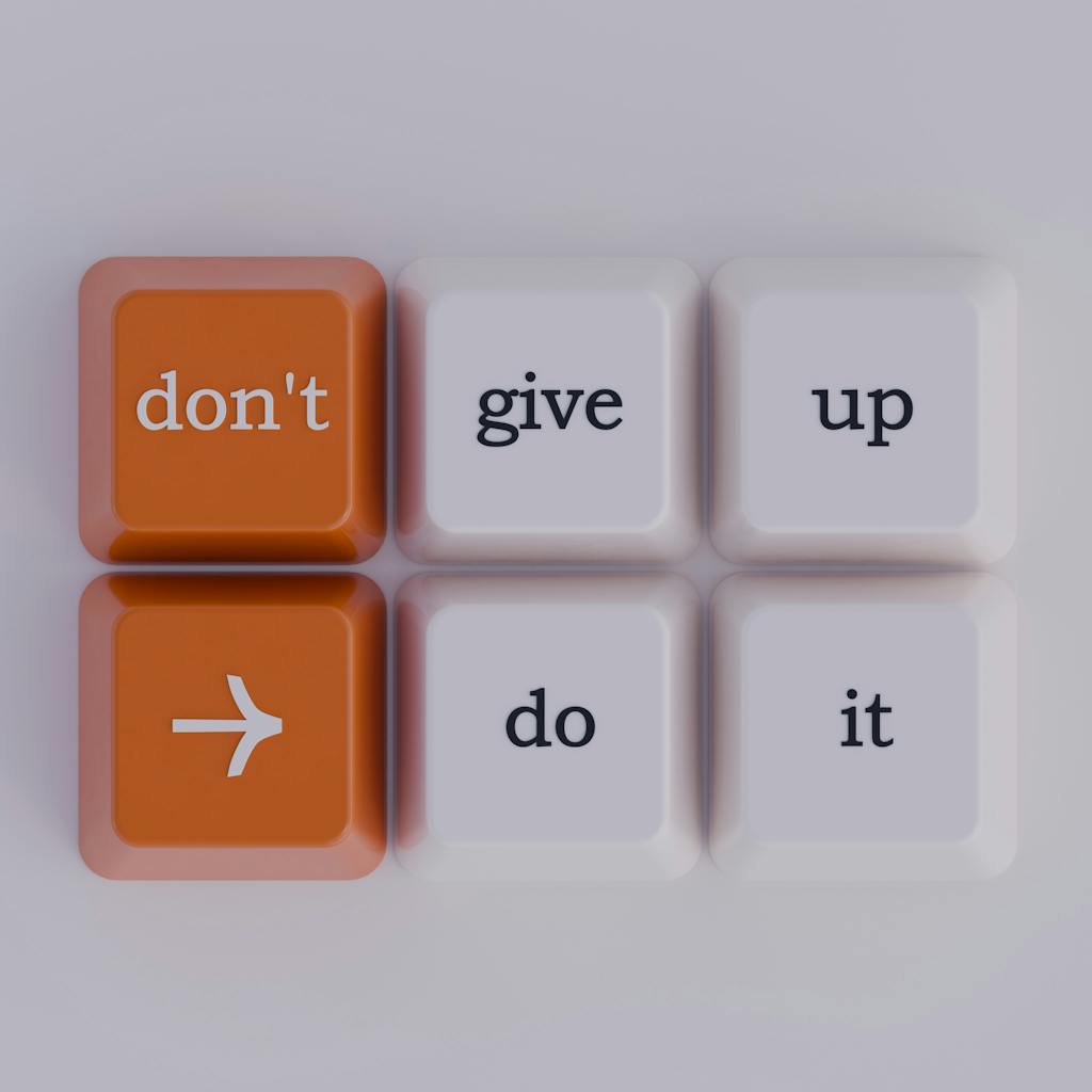 Keyboard keys spelling out 'don't give up' message, simple and inspiring.
